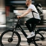 A boy riding his step-thru electric bikes rushing to college