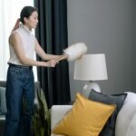 A woman trying to how to remove stains and maintain her sofa’s upholstery