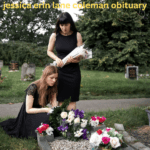 In a solemn tribute, two women in black dresses arrange flowers on graves for Jessica Erin Lane Coleman Obituary celebration of life.