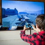 A young boy immersed in video games, focused on the TV screen, showcasing the excitement of gaming with Selenite Games