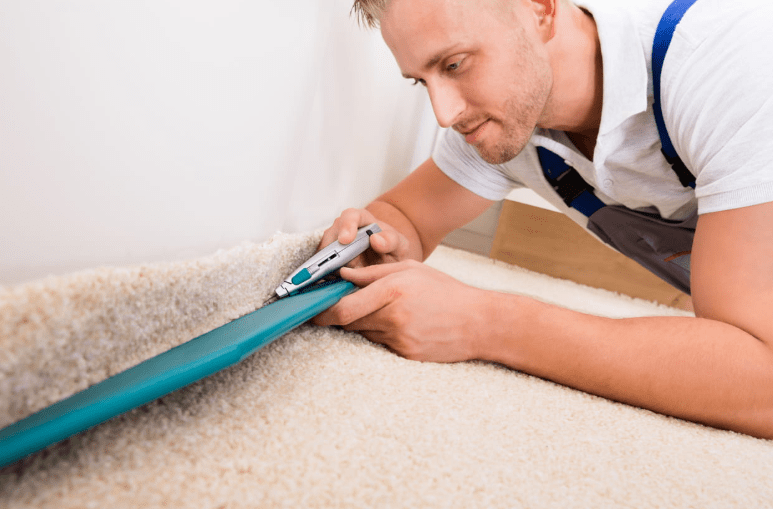 Man is trying to cut carpet